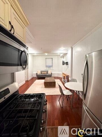 Brookline apartment for rent - A kitchen with white cabinets and a stainless steel stove.