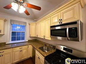 Brookline apartment for rent - A bathroom with a toilet, sink, mirror, and shower.