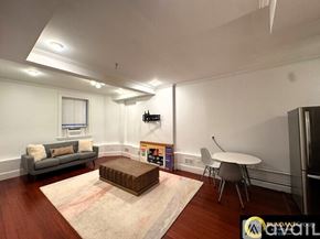 Brookline apartment for rent - A red brick building with a white door and steps leading up to it.