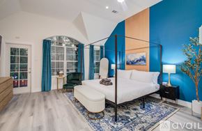 Spring house for rent - A bedroom with a white bed and a blue rug.