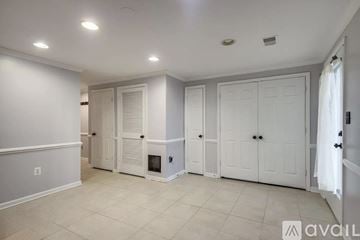 Sterling apartment for rent - A bedroom with a bed, nightstand, and chair.