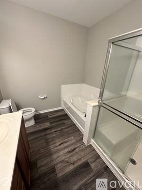 Pingree Grove condo for rent - A bathroom with a toilet, sink, and bathtub.