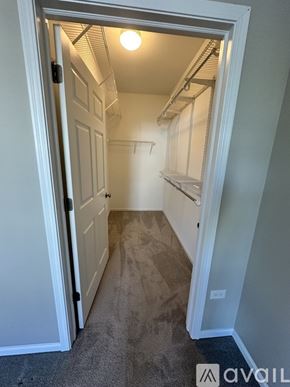 Pingree Grove condo for rent - A small, empty room with a door open to a hallway.