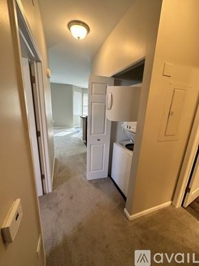Pingree Grove condo for rent - A small, empty room with a white door and a carpeted floor.