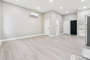 Baltimore apartment for rent - A spacious room with a refrigerator on the right side.