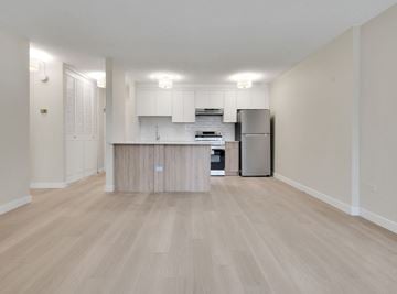 Calgary apartment for rent - A kitchen with a refrigerator, cabinets, and a countertop.