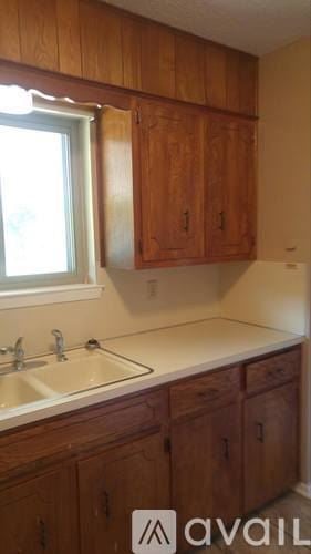 Killeen house for rent - A kitchen with wooden cabinets and a window.