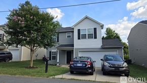 Charlotte apartment for rent - A house with a tree and two cars parked in front.