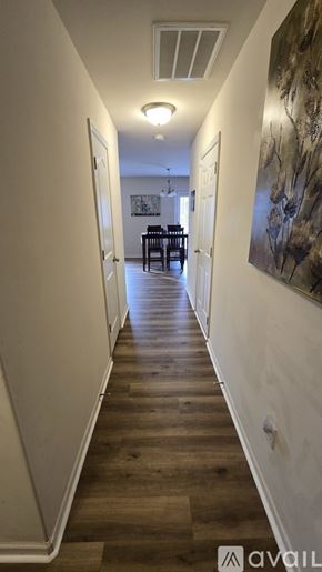 Charlotte apartment for rent - A dining room with a table set for six and a painting on the wall.