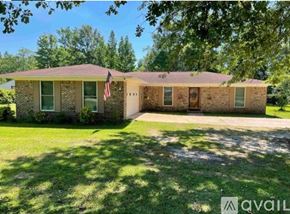 Atmore house for rent - A house with a flag on the front lawn.