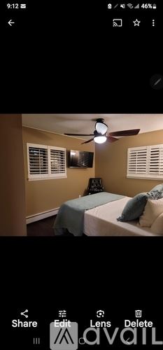 Cody house for rent - A bedroom with a bed and a ceiling fan.