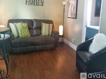 Cody house for rent - A living room with a brown couch and a black chair.