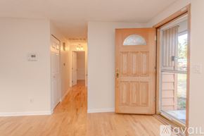 Auburn apartment for rent - A room with a wooden floor and a wooden door.