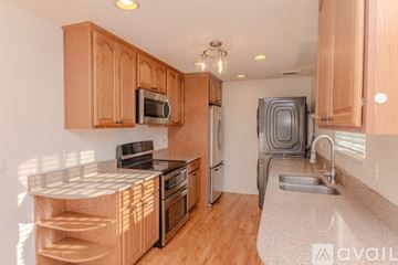 Auburn apartment for rent - A kitchen with wooden cabinets and stainless steel appliances.
