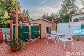 Auburn apartment for rent - A wooden deck with a table and chairs and a pool in the backyard.