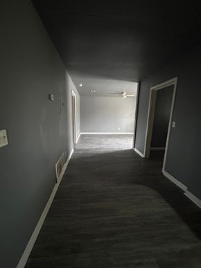 Killeen apartment for rent - A long, narrow hallway with a door on the right and a window on the left.