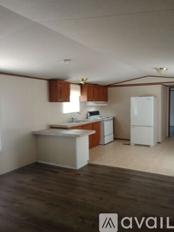 Bristol house for rent - A kitchen with white appliances and wooden cabinets.