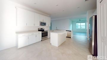 Englewood house for rent - A modern kitchen with white cabinets and appliances.