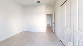 Englewood house for rent - A spacious room with a white door and a tiled floor.