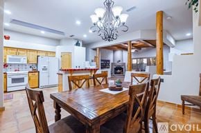 Lake Havasu City house for rent - A dining room with a wooden table and chairs.