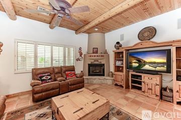 Lake Havasu City house for rent - A living room with a brown leather couch and a wooden coffee table.