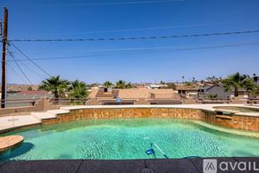 Lake Havasu City house for rent - A pool with a blue chair and a sign that says "available".
