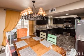 Lake Havasu City house for rent - A kitchen with a table and chairs in the foreground and a refrigerator in the background.