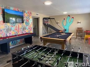 Lake Havasu City house for rent - A foosball table is in the middle of a room with a pool table and a TV.