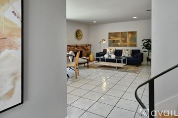 San Jose house for rent - A living room with a brick wall and a painting on the wall.