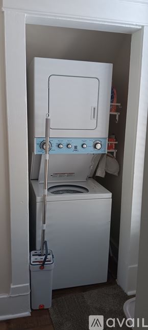 Pueblo house for rent - A white dryer is in a small white closet.