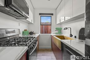 Los Angeles apartment for rent - A modern kitchen with a stove top oven and a window.