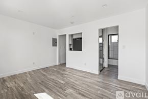 Los Angeles apartment for rent - A spacious room with wood flooring and white walls.