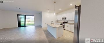 Port Charlotte house for rent - A modern kitchen with white cabinets and a large island.