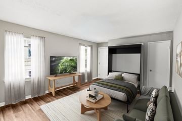 Louisville apartment for rent - A modern bedroom with a large bed and a television.