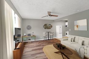 Louisville apartment for rent - A living room with a couch, a coffee table, and a television.