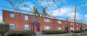 Louisville apartment for rent - A row of red brick houses with a black door and windows.