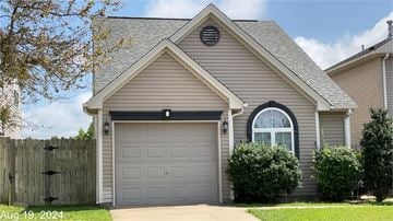 Owensboro house for rent - A house with a grey garage door and a window above it.