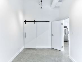 Toronto apartment for rent - A white room with a sliding door and a light fixture on the ceiling.