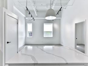 Toronto apartment for rent - A white room with a large white floor and a white ceiling with a light hanging from it.