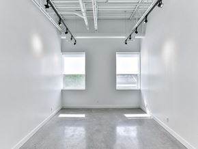 Toronto apartment for rent - A large empty room with a concrete floor and white walls.