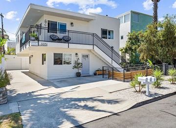 Dana Point apartment for rent - A white two-story house with a balcony on the upper floor.
