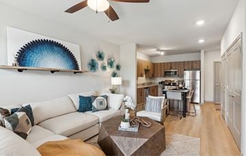 Savannah apartment for rent - A living room with a white couch and a ceiling fan.