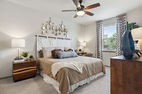 Savannah apartment for rent - A bedroom with a large bed and a ceiling fan.