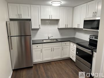 Lake Stevens apartment for rent - A kitchen with white cabinets and a stainless steel refrigerator.