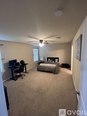 San Antonio house for rent - A bedroom with a bed, desk, and chair.