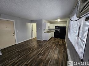 La Crosse apartment for rent - A kitchen area with wooden floors and white walls.