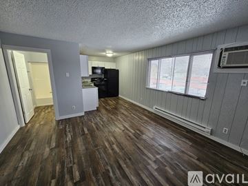 La Crosse apartment for rent - A kitchen with a black refrigerator and white cabinets.