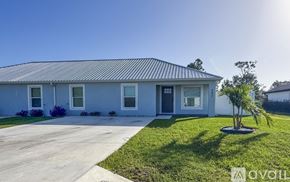 Sebring house for rent - A living room with a white sofa, a wooden coffee table, and a ceiling fan.