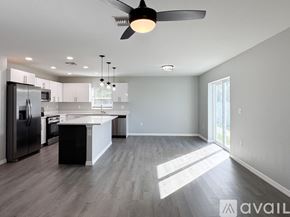 Sebring house for rent - A living room with a couch, a coffee table, and a ceiling fan.
