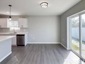Sebring house for rent - A modern kitchen with a dining table and chairs.
